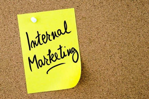Internal Marketing text written on yellow paper note pinned on cork board with white thumbtack. Business concept image with copy space available