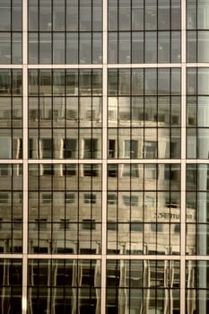 London,UNITED KINGDOM – November 29,2014: The reflection of the Thomson Reuters office building in the modern mirror façade of another office building on 29 November 2014 in London.