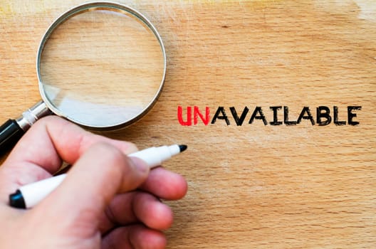Human hand over wooden background and unavailable text concept