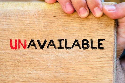 Human hand over wooden background and unavailable text concept