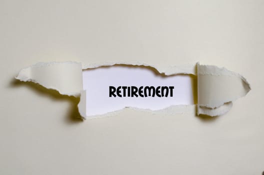 The word retirement appearing behind torn paper