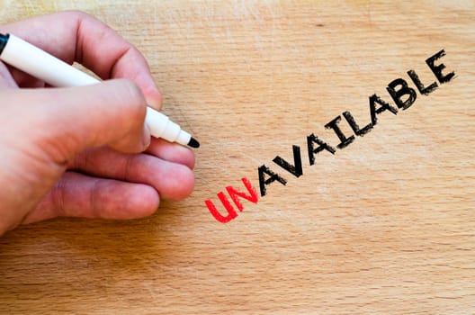 Human hand over wooden background and unavailable text concept