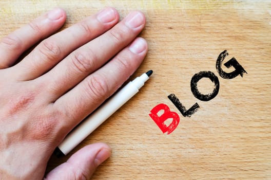 Human hand over wooden background and blog text concept