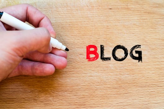 Human hand over wooden background and blog text concept
