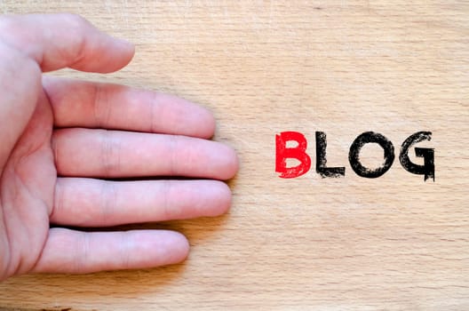 Human hand over wooden background and blog text concept