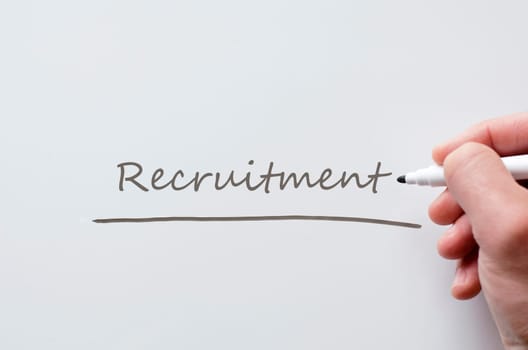 Human hand writing recruitment on whiteboard