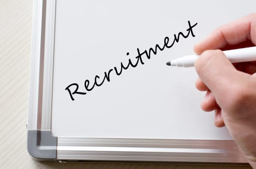Human hand writing recruitment on whiteboard