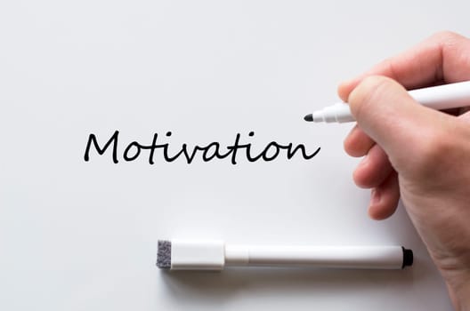 Human hand writing motivation on whiteboard