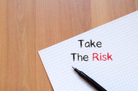 Take the risk text concept write on notebook