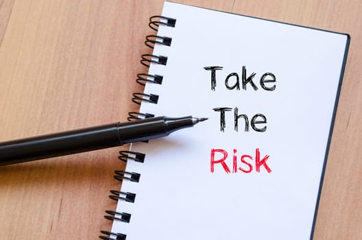 Take the risk text concept write on notebook