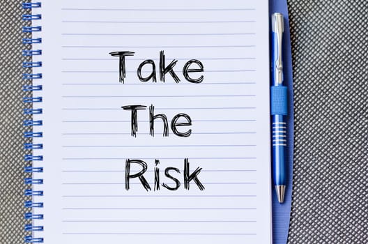 Take the risk text concept write on notebook
