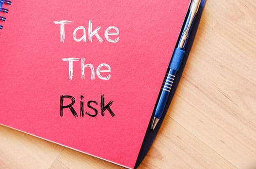 Take the risk text concept write on notebook