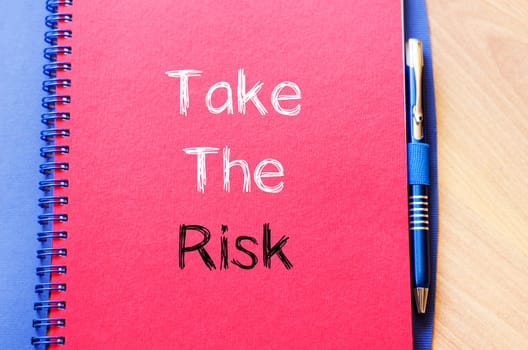 Take the risk text concept write on notebook