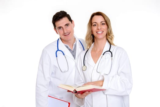 young friendly medical team with book in lab coat in front of white background