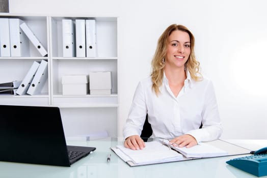 young blond businesswoman working in the office