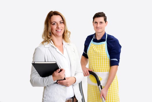 young beautiful businesswoman and her husband with vacuum cleaner in background