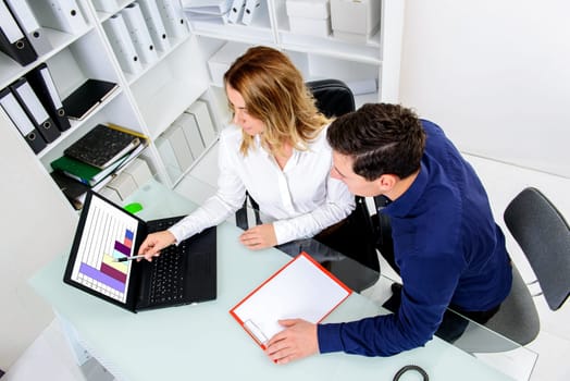 young businessman and businesswoman working together in the office