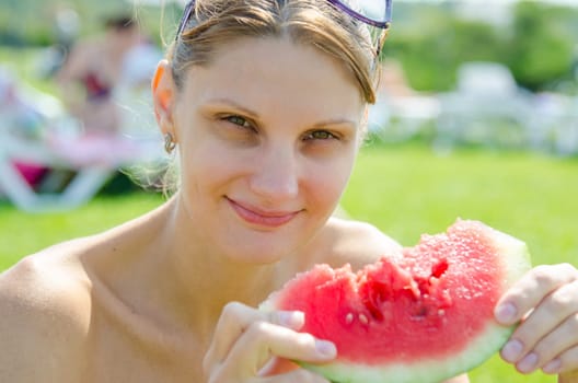 Young girl eating watermelon, close up portrait