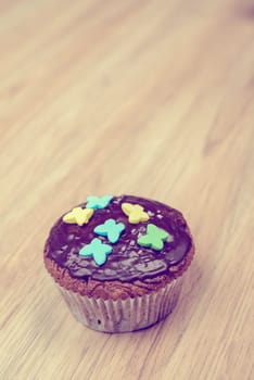 chocolate muffin with in vintage look on wooden ground