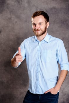 young bearded man is surprised and pointing in to the camera