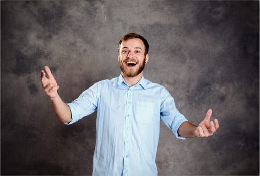 young bearded man is surprised and showing open hands