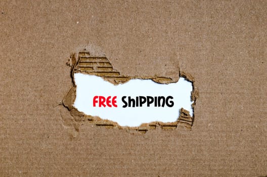 The word free shipping appearing behind torn paper