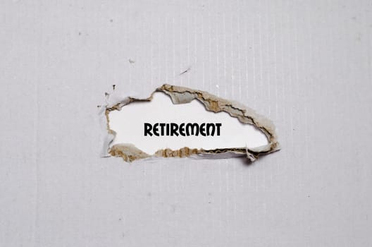 The word retirement appearing behind torn paper