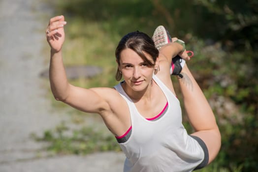 beautiful young fitness woman doing exercise in countryside