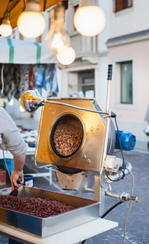 Cooking machine the sugared almonds. Caramelized almonds, produced at the time, are a typical dessert in festivals in Italy.