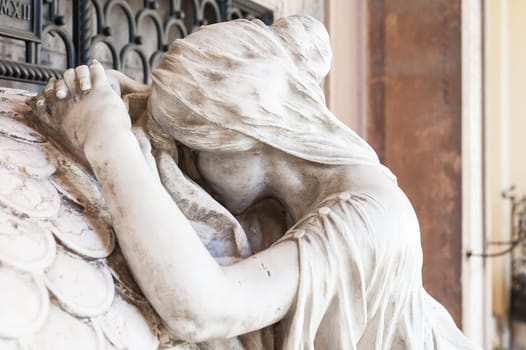 More than 100 years old statue. Cemetery located in North Italy.