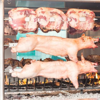 Carcasses of pork and other meat prepared on skewer.