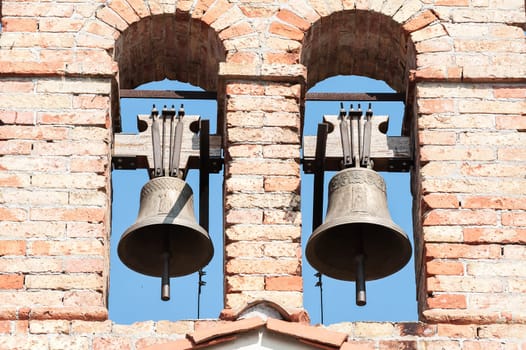 Small bell tower with a bell of a country church in the 14th century