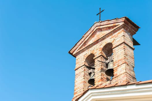 Small bell tower with a bell of a country church in the 14th century