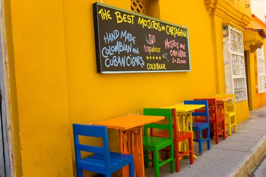 CARTAGENA, COLOMBIA - MAY 23: Colorful chairs and sign of a restaurant in Cartagena, Colombia on May 23, 2016