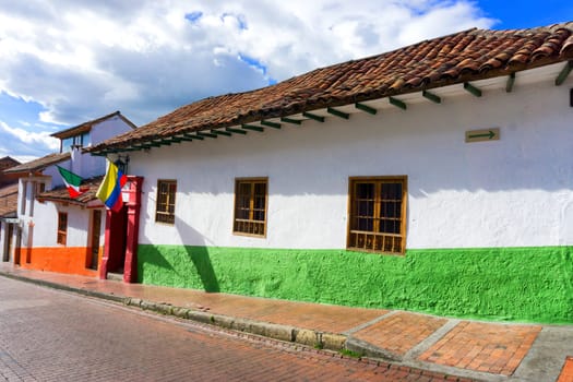 Colonial street with Colombian and Mexican flags in La Candelaria neighborhood in Bogota, Colombia