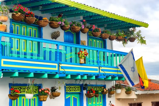 Colorful architecture and flowers with Colombian and Israeli flags in Salento, Colombia