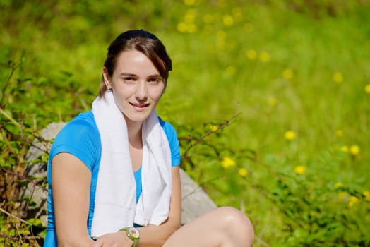 beautiful sporty young  woman relaxing after exercising
