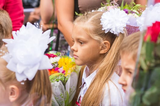 First grader standing in a crowd of children on line the first of September