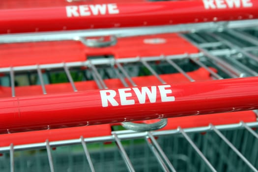 Shopping trolley with REWE logo in close-up
