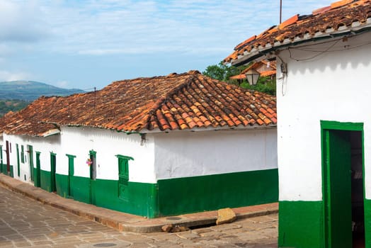 Green and white colonial street corner in Barichara, Colombia