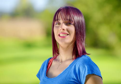 portrait of a young woman with green eyes and red hairs, outdoors