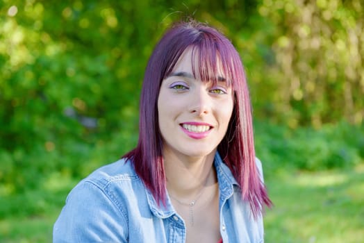 portrait of a young woman with green eyes and red hairs, outdoors