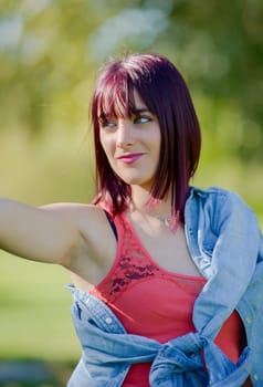 portrait of a young woman with green eyes and red hairs, outdoors