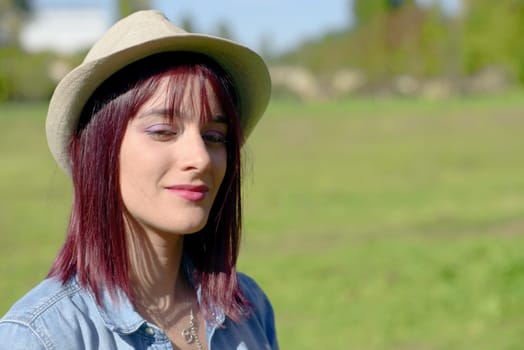 beautiful young woman with  hat in the park