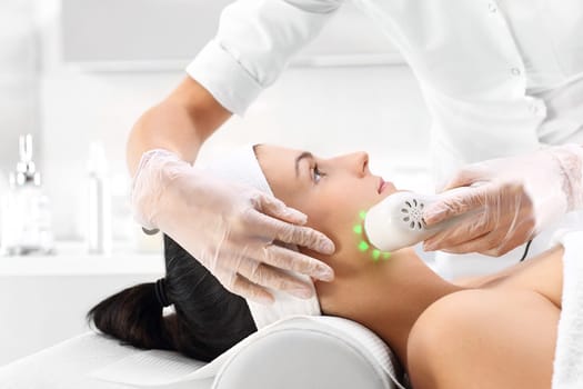 phototherapy,beauty treatment,ultrasonic massage. light skin treatment,a woman in a beauty salon. a woman's face during a treatment at a beauty salon. ultrasound infrared light,facial treatment\n\n\n