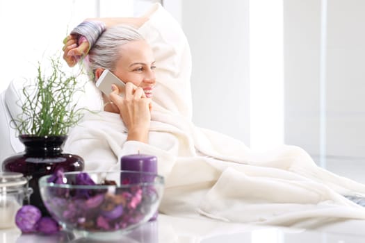 beauty parlor,a beautiful woman talking on the phone.\nwellness,woman relaxing in the beauty salon\n