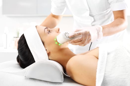 phototherapy,cosmetic surgery,ultrasonic massage. skin treatment with light,woman in beauty salon. face of a woman during surgery in a beauty salon. ultrasounds of infrared light,cosmetic surgery on the face\n\n\n