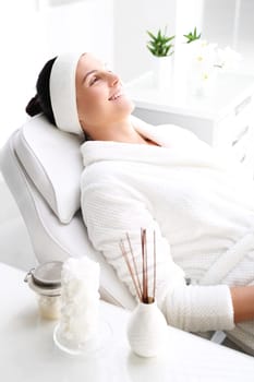 woman in a beauty salon.\nwoman at the spa.\na woman relaxing in a beauty salon.\n