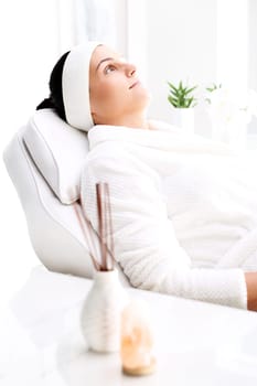 woman in a beauty salon.\nwoman at the spa.\na woman relaxing in a beauty salon.\n