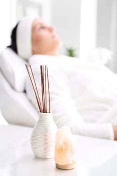 woman in a beauty salon.\nwoman at the spa.\na woman relaxing in a beauty salon.\n